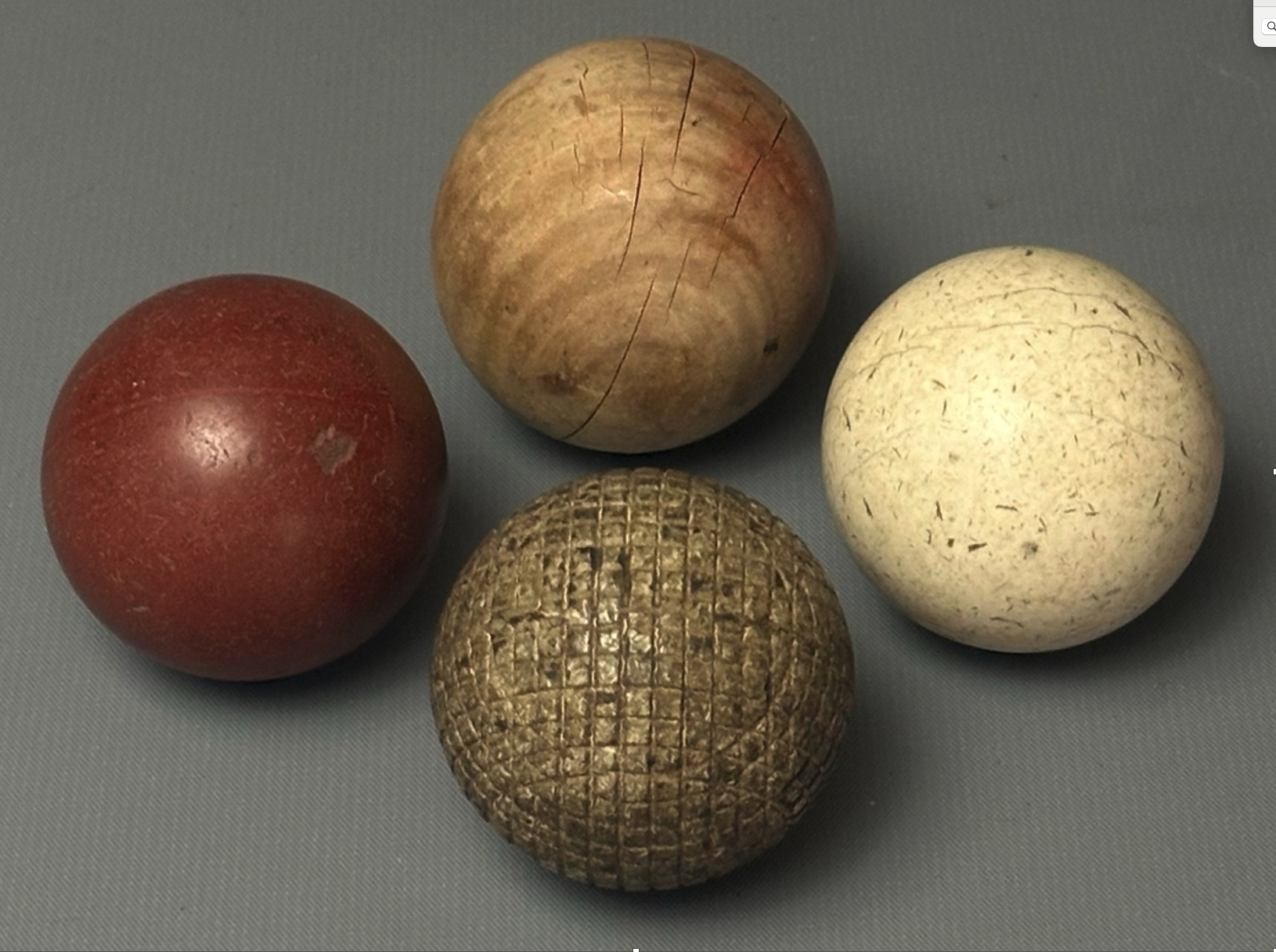 Bagatelle balls and wooden ball with golf ball reference